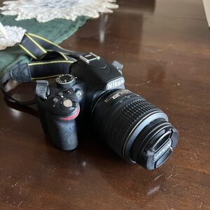 Nikon DSLR Camera in Black with Yellow-Accent Strap